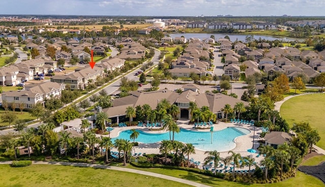 drone / aerial view featuring a residential view and a water view