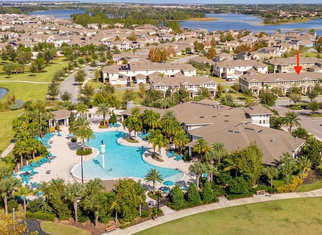 drone / aerial view with a water view and a residential view