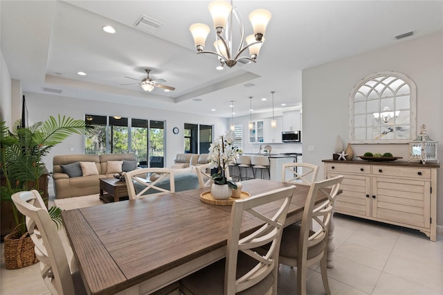 dining area with visible vents, a tray ceiling, and recessed lighting