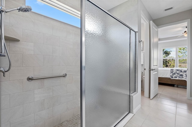 bathroom with a ceiling fan, visible vents, tile patterned floors, a stall shower, and ensuite bath