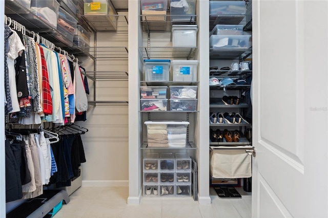 walk in closet with tile patterned floors