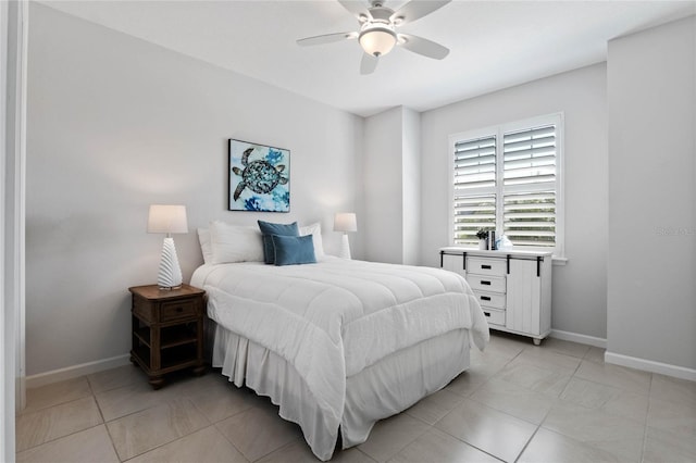 bedroom featuring ceiling fan, baseboards, and light tile patterned floors