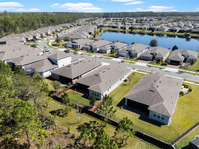 drone / aerial view featuring a water view and a residential view