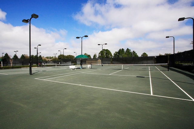 view of tennis court featuring fence