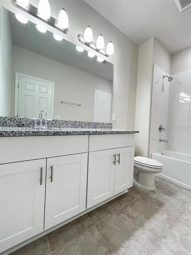 bathroom featuring double vanity, visible vents, toilet, washtub / shower combination, and a sink