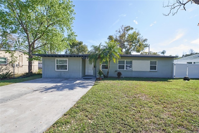 single story home with driveway, a front yard, and fence