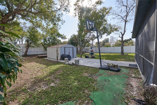 view of yard featuring a patio area, a fenced backyard, a storage unit, and an outdoor structure