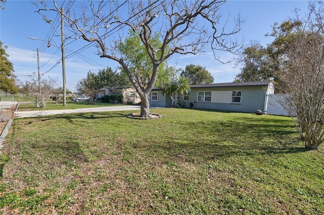 view of yard featuring driveway and fence