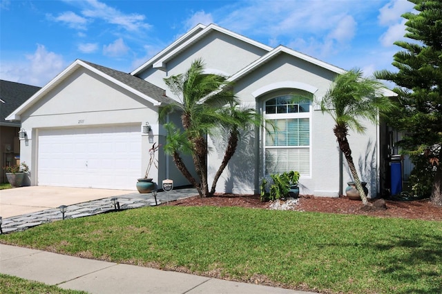 ranch-style home with a garage, concrete driveway, a front lawn, and stucco siding