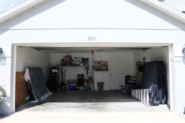 garage featuring concrete driveway