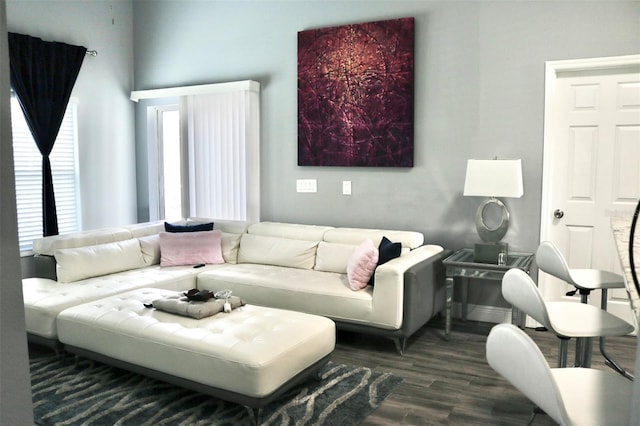 living area featuring dark wood-style floors and baseboards