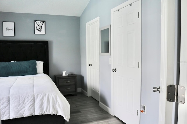 bedroom with baseboards and wood finished floors