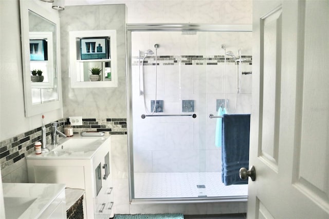 full bathroom featuring a stall shower and vanity