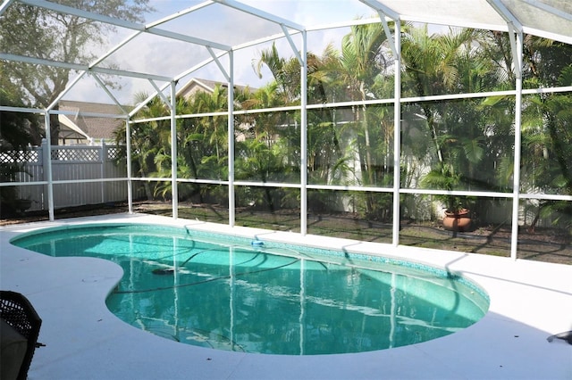 view of pool featuring a fenced in pool, glass enclosure, and a patio