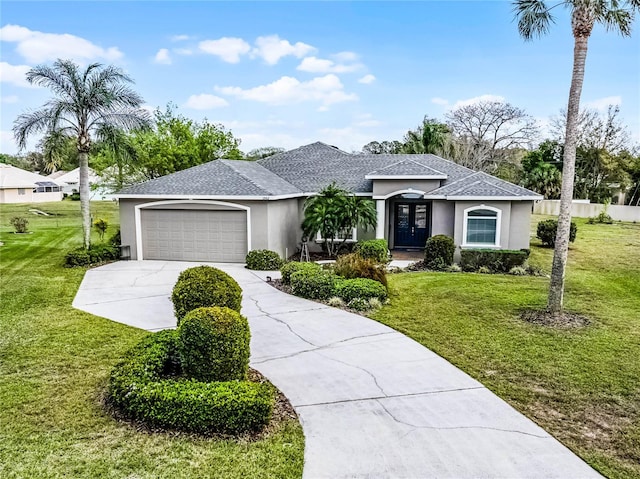 view of front of house featuring a shingled roof, a front yard, and stucco siding