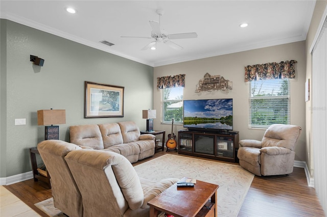 living room with baseboards, visible vents, wood finished floors, and ornamental molding