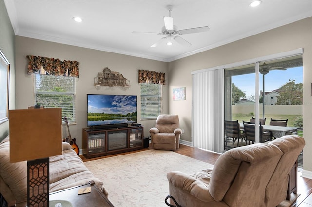 living area featuring baseboards, a ceiling fan, ornamental molding, wood finished floors, and recessed lighting