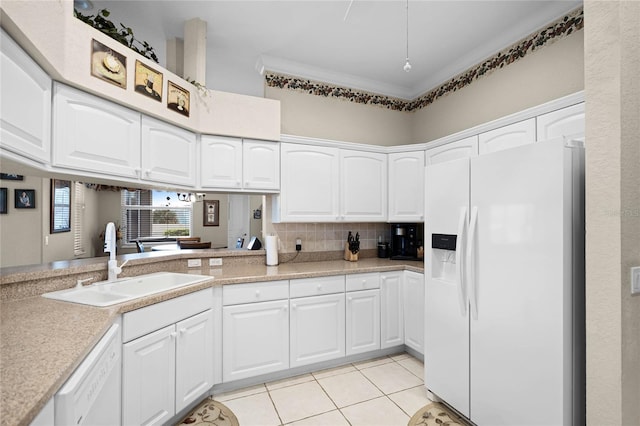 kitchen with decorative backsplash, light tile patterned flooring, a sink, white cabinets, and white appliances