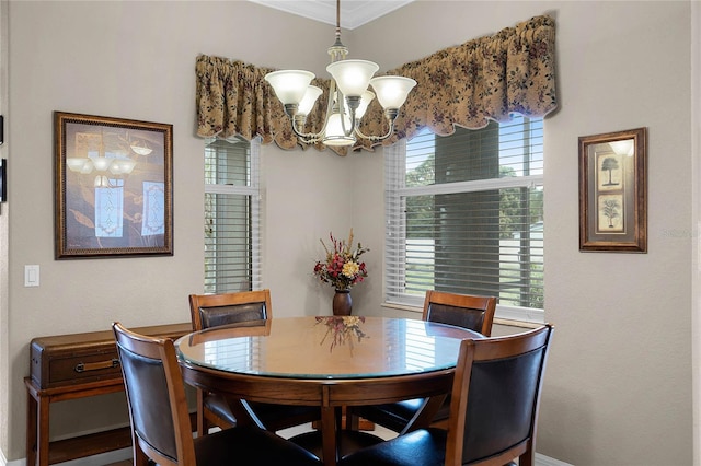 dining space with crown molding, a wealth of natural light, and a notable chandelier