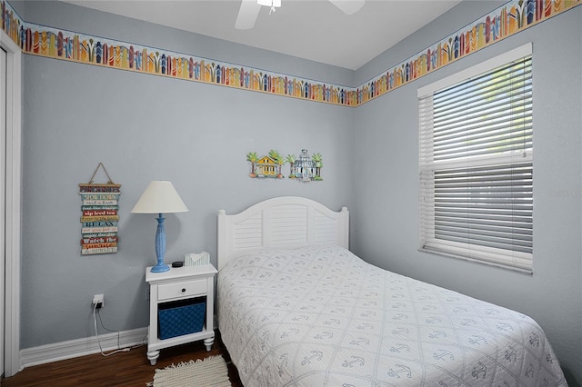 bedroom featuring a ceiling fan, baseboards, and wood finished floors