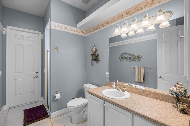 full bath featuring toilet, vanity, baseboards, a shower stall, and tile patterned floors