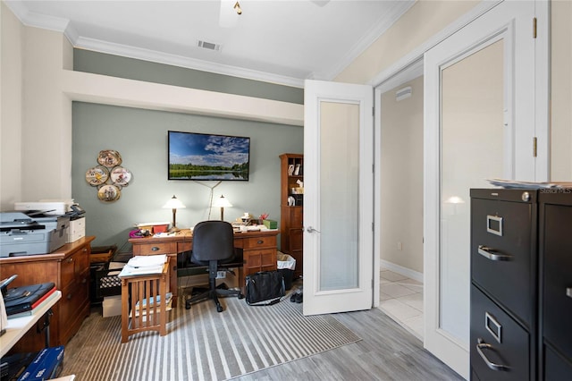 home office featuring visible vents, wood finished floors, crown molding, and french doors