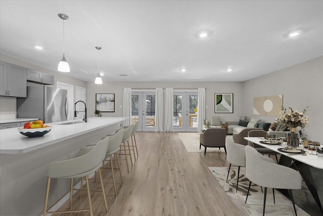 dining room featuring french doors, light wood-type flooring, and recessed lighting