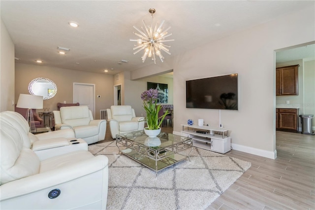 living room with light wood finished floors, baseboards, visible vents, a chandelier, and recessed lighting