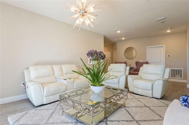 living area featuring a chandelier, recessed lighting, wood finished floors, visible vents, and baseboards