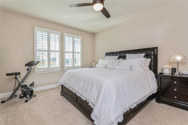 bedroom featuring light carpet, ceiling fan, and baseboards