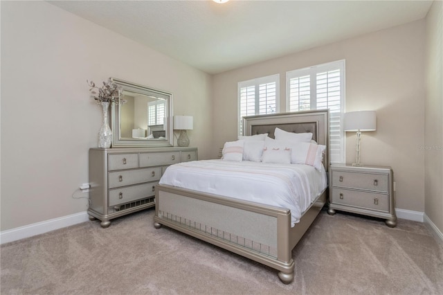 carpeted bedroom featuring baseboards