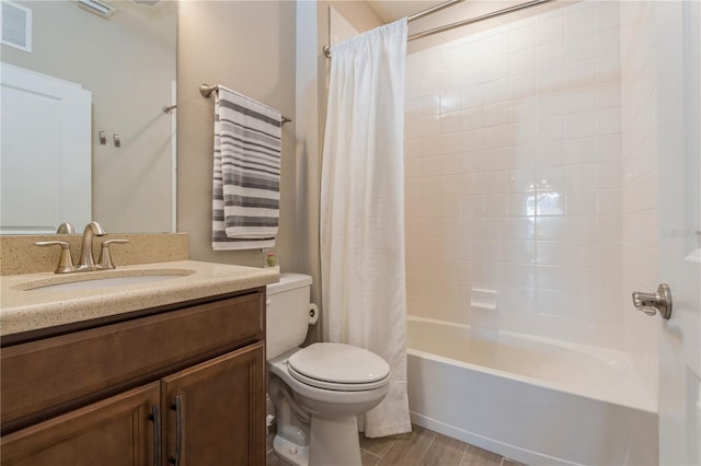 bathroom with visible vents, toilet, wood finished floors, shower / bathtub combination with curtain, and vanity