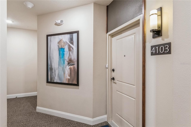 interior space featuring carpet and baseboards