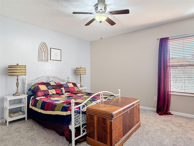 bedroom featuring a textured ceiling, ceiling fan, carpet flooring, and baseboards