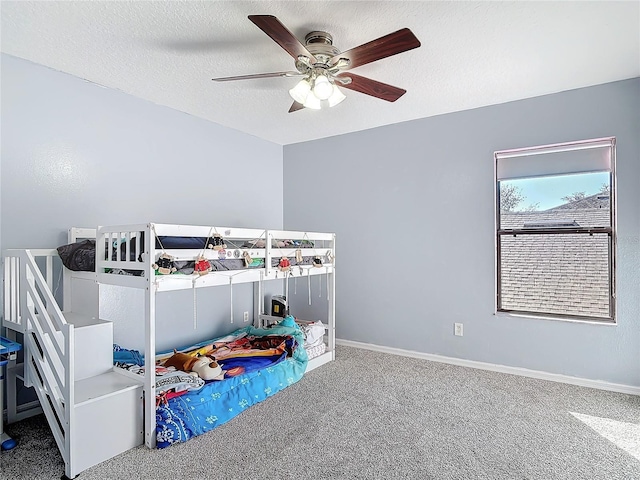 bedroom with carpet flooring, ceiling fan, a textured ceiling, and baseboards