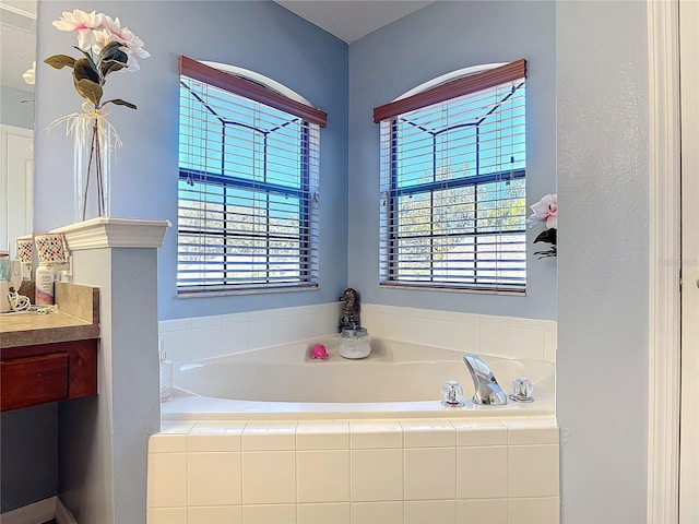 full bathroom featuring vanity and a bath