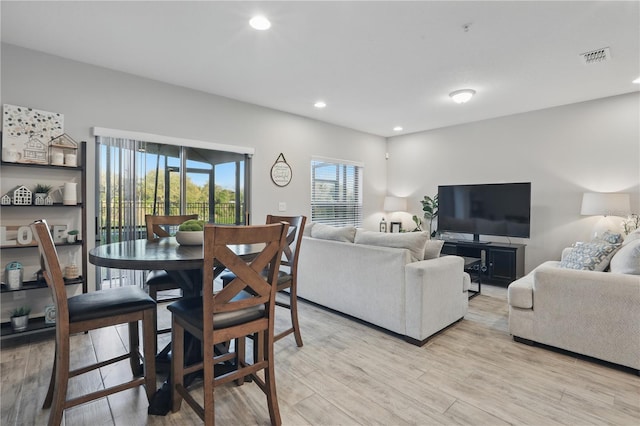 dining room with light wood-style floors, recessed lighting, and visible vents