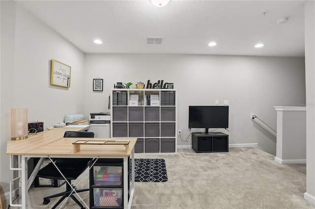 carpeted office space featuring baseboards, visible vents, a textured ceiling, and recessed lighting