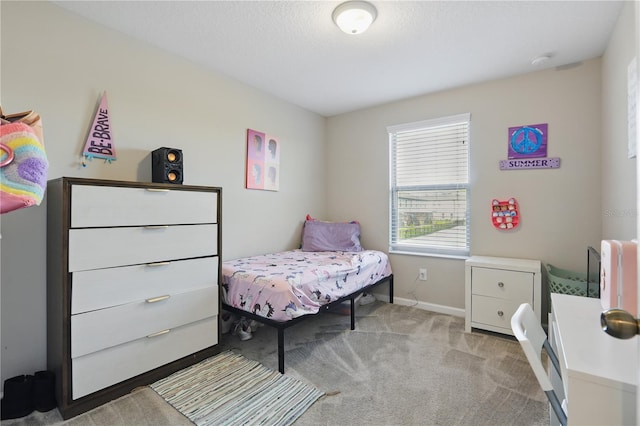 bedroom with carpet floors, a textured ceiling, and baseboards