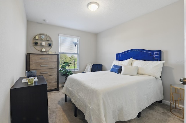 bedroom with a textured ceiling and light colored carpet