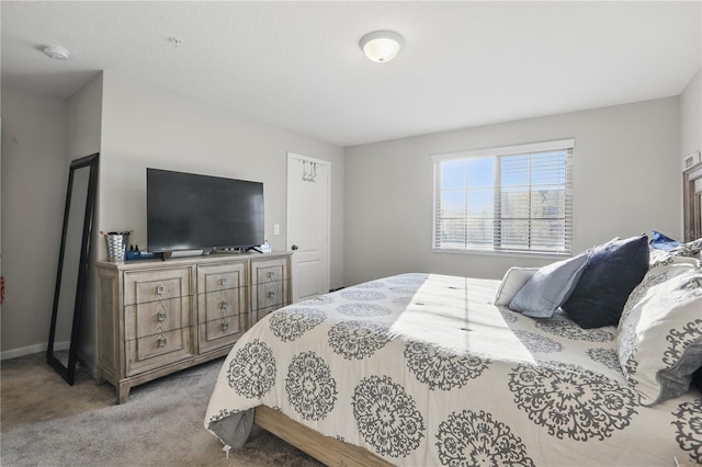 bedroom with light carpet and baseboards