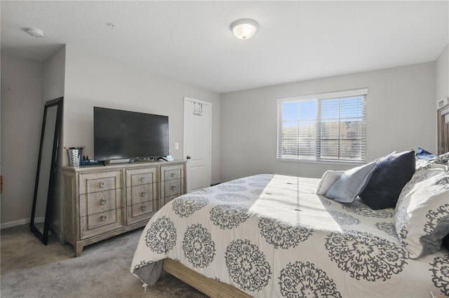 bedroom featuring carpet and baseboards