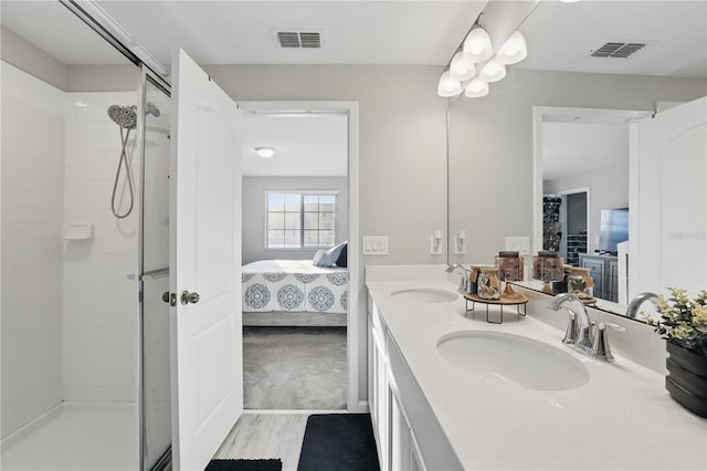 full bath featuring a tile shower, a sink, and visible vents