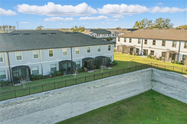 view of home's community with a lawn, a fenced backyard, and a residential view