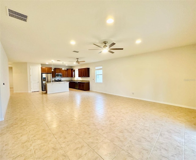 unfurnished living room featuring visible vents, ceiling fan, and baseboards