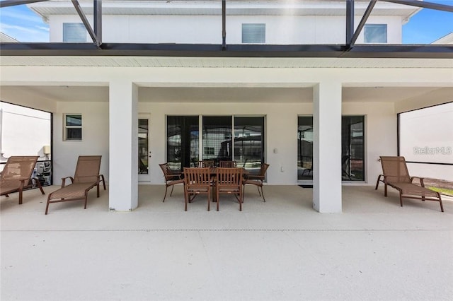 view of patio featuring a lanai