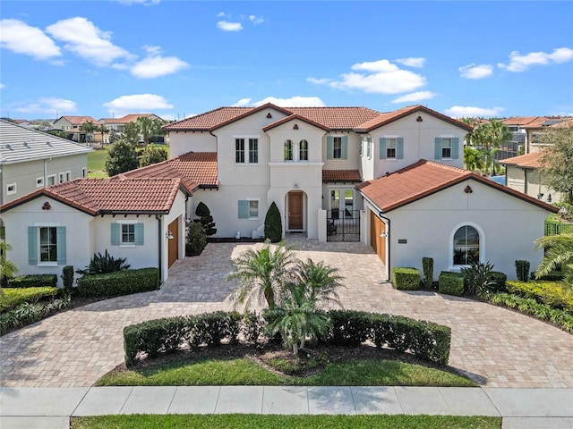 15644 Panther Lake Dr, Winter Garden, FL 34787 - mediterranean / spanish-style home with a tile roof, a residential view, decorative driveway, and stucco siding