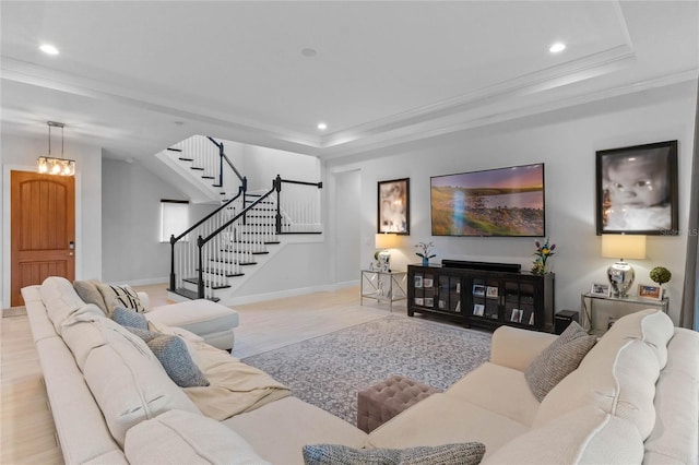 living room featuring a tray ceiling, stairway, recessed lighting, and crown molding