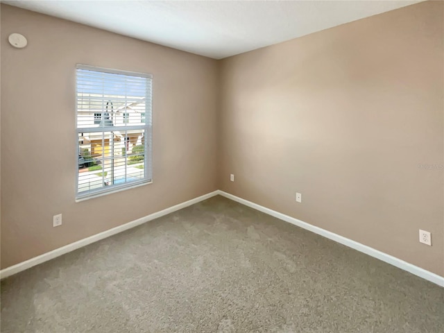 spare room with carpet flooring and baseboards