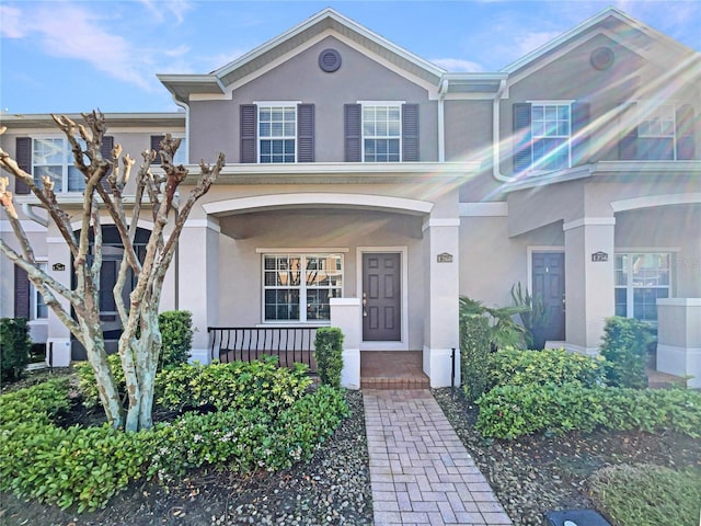 view of front of property with covered porch and stucco siding